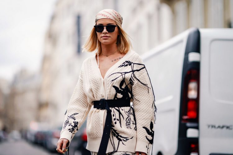 PARIS, FRANCE - MARCH 02: Julia Kuczynska "Maffashion" wears a bandanna from Gucci, a white wool jacket with print depicting nature, white pants, a Prada bag, white boots, outside Elie Saab, during Paris Fashion Week Womenswear Fall/Winter 2019/2020, on March 02, 2019 in Paris, France. (Photo by Edward Berthelot/Getty Images)