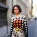 PARIS, FRANCE - OCTOBER 04: Marta Cygan wears a wool pullover with printed black orange and white dots, a belt with golden buckle, a white floral print colored skirt, a metallic bag, outside Paco Rabanne, during Paris Fashion Week - Womenswear Spring Summer 2021, on October 04, 2020 in Paris, France. (Photo by Edward Berthelot/Getty Images)