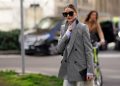 MILAN, ITALY - FEBRUARY 21: Olivia Palermo wears sunglasses, a gray oversized blazer jacket, a blue striped shirt, blue and white striped pants, outside Etro, during Milan Fashion Week Fall/Winter 2020-2021 on February 21, 2020 in Milan, Italy. (Photo by Edward Berthelot/Getty Images)